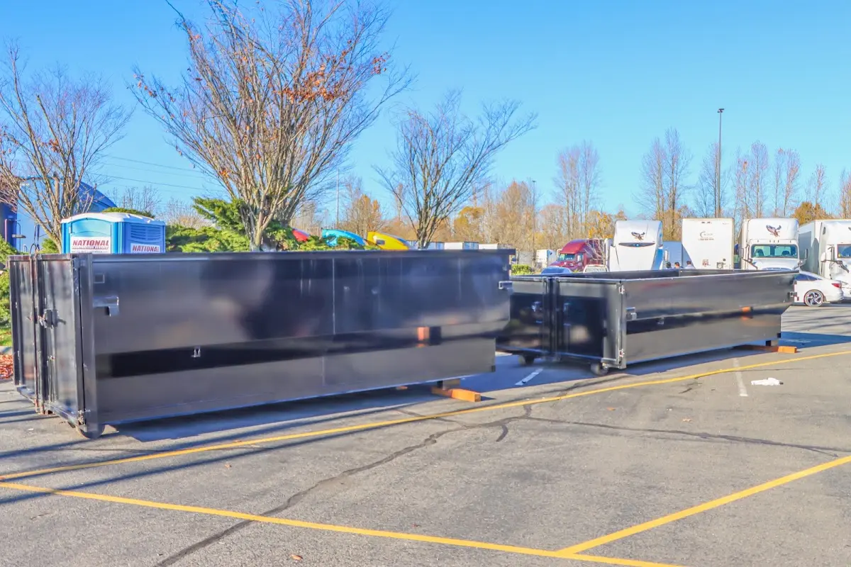 Professional dumpster rental service with roll-off container on residential driveway in Park Hills